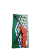 Blow gun with orange handle on green packaging against a white background